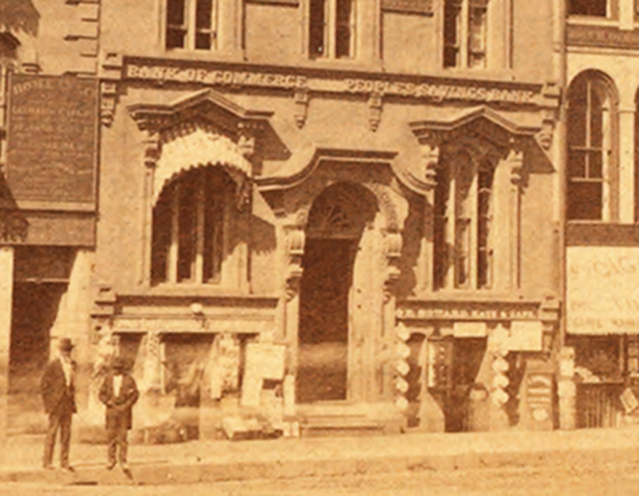 Detail showing the office of the Commerce Bank, beside the Peoples Savings Bank.