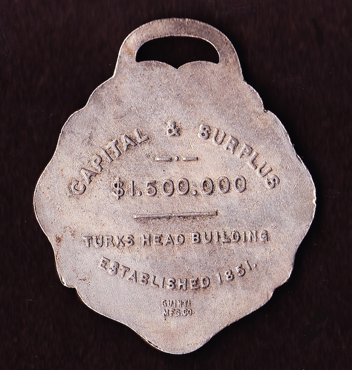 Reverse of Bank of Commerce key fob, showing the Turks Head location. 